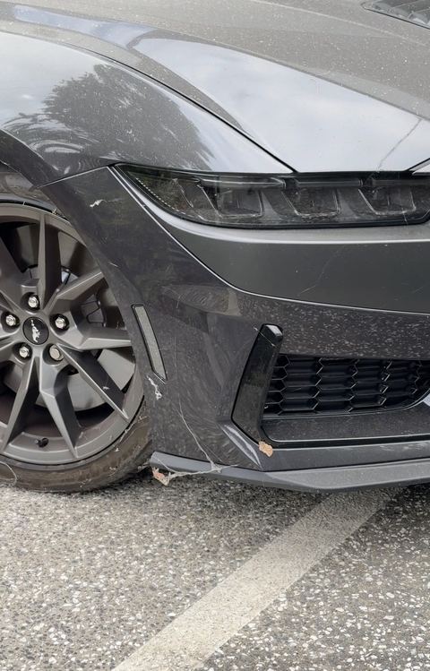 Ford Mustang Dark Horse front corner, bumper and wheel before cleaning